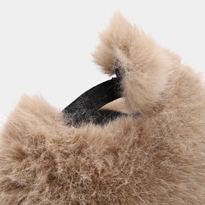 Macro detail of plush faux fox fur texture and elastic strap on the winter baseball cap
