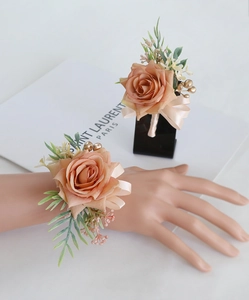 Detailed shot of champagne rose wrist corsage and boutonniere set with silk ribbons