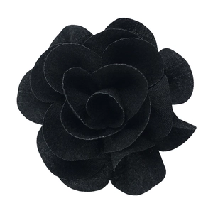 Detailed close-up of a handmade 7cm black bubble crepe fabric flower with layered petals