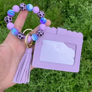 Detailed view of purple silicone bead bracelet keychain with leopard print and PU card holder