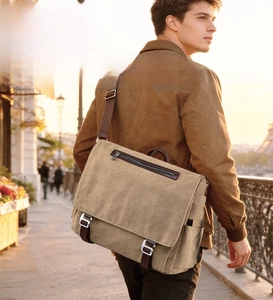 Detailed view of khaki canvas messenger bag with metal buckle and shoulder strap