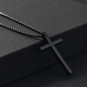 Men's hip hop black stainless steel cross pendant necklace on textured background
