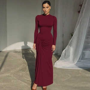 Detailed view of the burgundy maxi dress showing tie-waist knot and sleek draped fabric