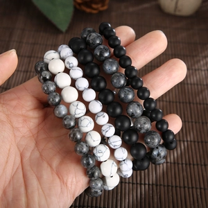 Detailed view of matte black agate and turquoise beads on a beaded wolf head bracelet