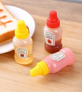 Macro view of portable mini squeeze bottles for sauces on a wooden board