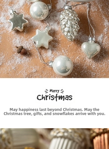 Detailed view of pearl white Christmas ornaments including stars and pinecones on snow