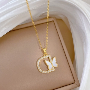 Elegant gold D-letter pendant necklace with sparkling diamonds and white butterfly accent