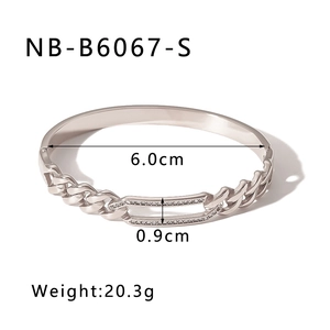 Macro detail of silver twist textured hollow bangle with crystal inlay and size dimensions