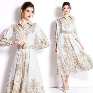 Close-up of vintage golden paisley print on a white maxi dress with matching belt