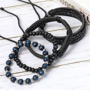 Close-up of multilayer leather and wood bead bracelets showing rich textures and alloy details