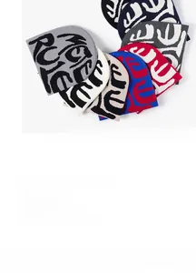 Close-up of assorted colorful knitted beanies with jacquard patterns for winter warmth