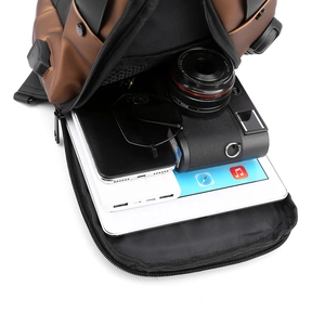 Top-down view of organized interior storage for iPad, camera, and tech gear in a chest bag