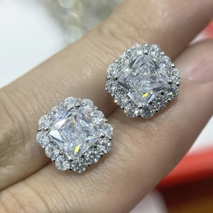 Macro detail of square cut cubic zirconia halo stud earrings in polished silver setting