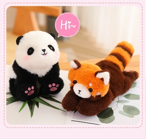 Adorable plush panda and red panda slap bracelets shown on a decorated wooden surface.