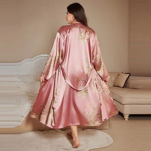 Elegant pink silk robe for women with floral print back view in a cozy bedroom setting