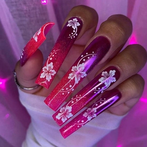 Macro detail of long coffin press-on nails with pink gradient and white hibiscus flowers