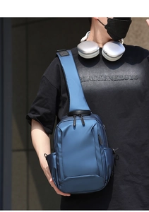 Close-up of waterproof dark blue chest bag showing smooth texture and zipper detail