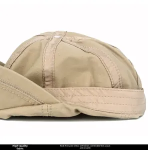 Detailed macro view of khaki cotton docker hat showing premium stitching and fabric texture