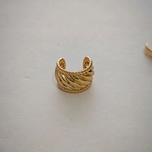 Detailed view of golden spiral textured ear cuff with beaded edges for non-pierced ears