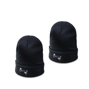 Classic black knitted beanie featuring a colorful SMILE and rainbow embroidery design