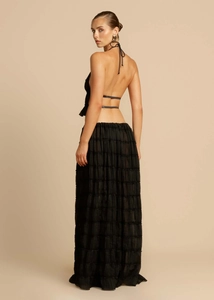 Detail of black backless halter top and layered pleated maxi skirt set with elegant drape