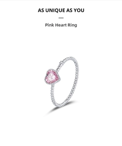 Macro detail of S925 sterling silver twisted band with a pink heart-shaped zircon