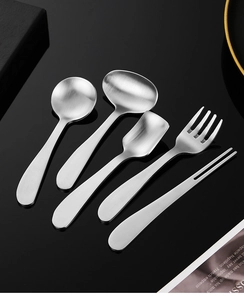 Detailed close-up of 304 stainless steel dessert spoons and forks set on black background