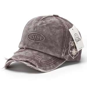 Close-up of distressed denim baseball cap featuring Boston embroidery and vintage holes