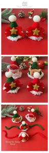 Close-up of handmade crochet pet Christmas hats with reindeer and Santa designs
