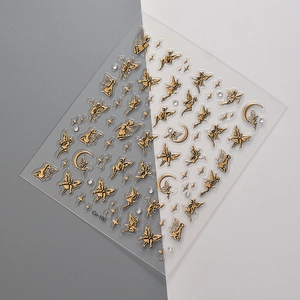 Golden fairy and moon nail art stickers with glitter finish on a minimal background
