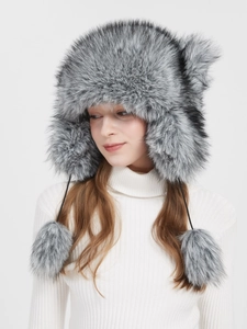 Faux fur trapper hat with raccoon style ear flaps and decorative fuzzy poms for winter