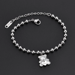 Close-up of a silver stainless steel bead bracelet with a bear and heart love pendant