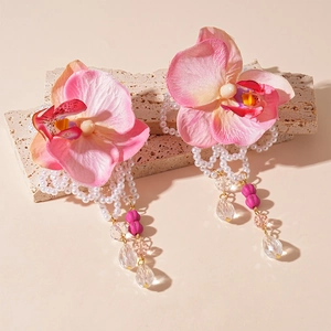 Pink fabric orchid drop earrings with pearl tassels and crystal accents on stone base
