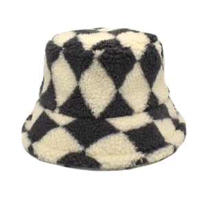 Detailed view of plush lamb wool bucket hat with black and white checkered pattern texture