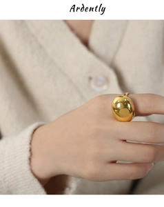 Macro detail of high-polished 18k gold chunky dome ring showing shiny mirror finish