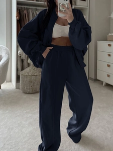 Détail d'un ensemble bleu marine deux pièces avec pantalon large et veste zippée