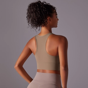 Detail view of khaki racerback sports bra and high-waist pink yoga leggings