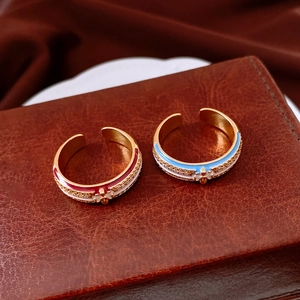 Detail of 18k gold plated open rings with colorful enamel flower and zircon inlay