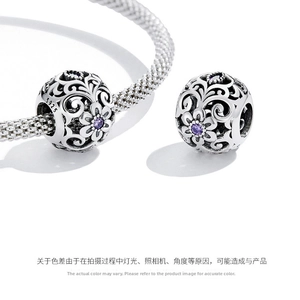 Macro detail of S925 silver floral charm with purple zircon for DIY bracelets