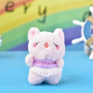 Close-up of a cute pink plush cat pendant with a white lace skirt and embroidered text