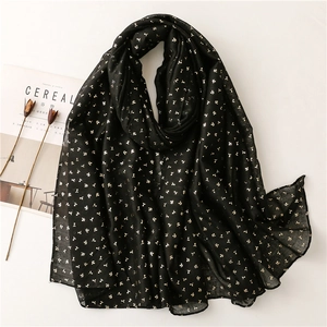 Detail of black cotton-linen scarf with gold foil bean sprout print and rolled edges