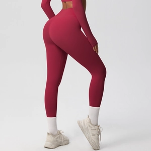 Close-up of high-waist yoga leggings and long-sleeve top in burgundy athletic fabric
