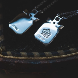 Macro view of S925 sterling silver perfume bottle pendant with crown and hallmark