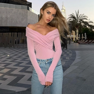 Detail of pink long sleeve bodysuit featuring off-shoulder crossover neckline design