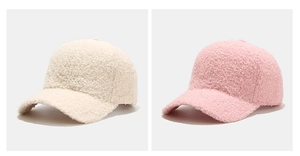 Close-up detail of plush lamb wool texture on cream and pink winter baseball caps