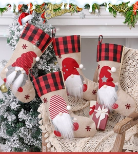 Four rustic Christmas stockings with gnome plush decor hanging by a festive fireplace