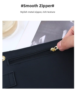Détail de la fermeture éclair en métal doré et texture tissée noire du sac de téléphone