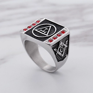 Macro view of Masonic signet ring with red crystal inlay and engraved G compass symbol