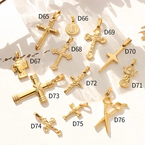 Collection of 12 vintage 18K gold plated titanium steel cross pendants on white wood