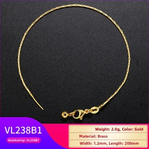 Detailed macro view of 1.2mm gold brass snake chain with lobster clasp and bead slider